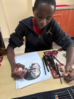 Kalimu with his artwork